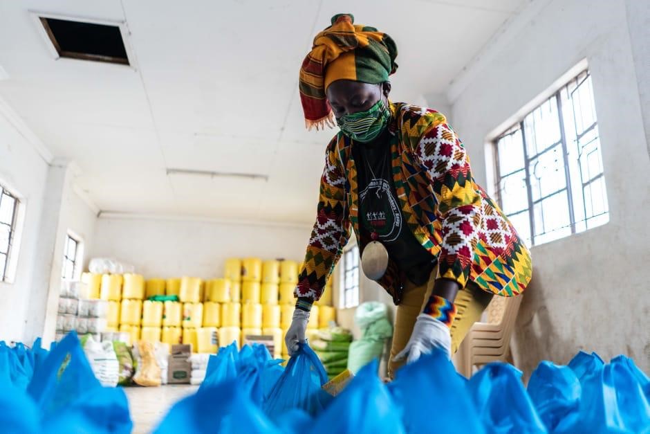 Rachael Mwikali preparing food stuffs at a local warehouse for distribution to her community