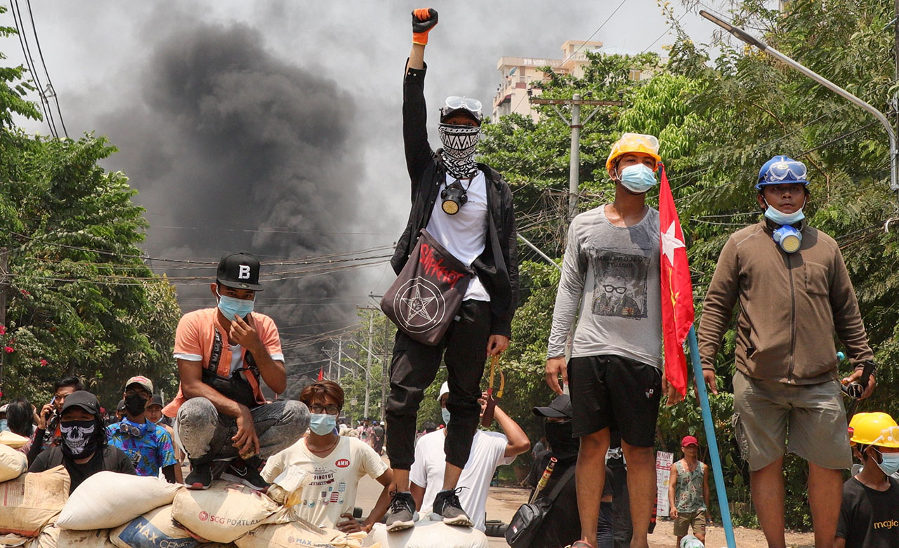 Plusieurs personnes sur une barricade durant les manifestations contre le coup d’État militaire à Yangon, au Myanmar, le 27 mars 2021. REUTERS/Stringer