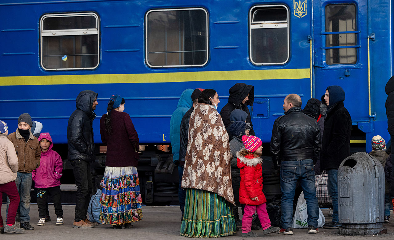 A family waiting at a train station. 