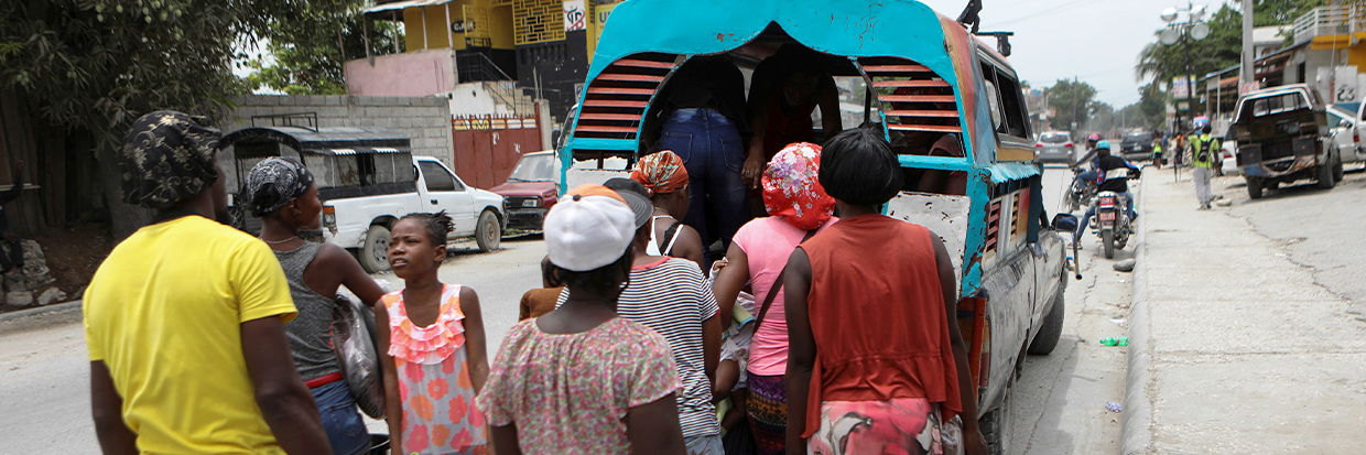 People carry belongings as they flee their homes due to ongoing gun battles between rival gangs, in Port-Au-Prince, Haiti April 28, 2022. REUTERS/Ralph Tedy Erol