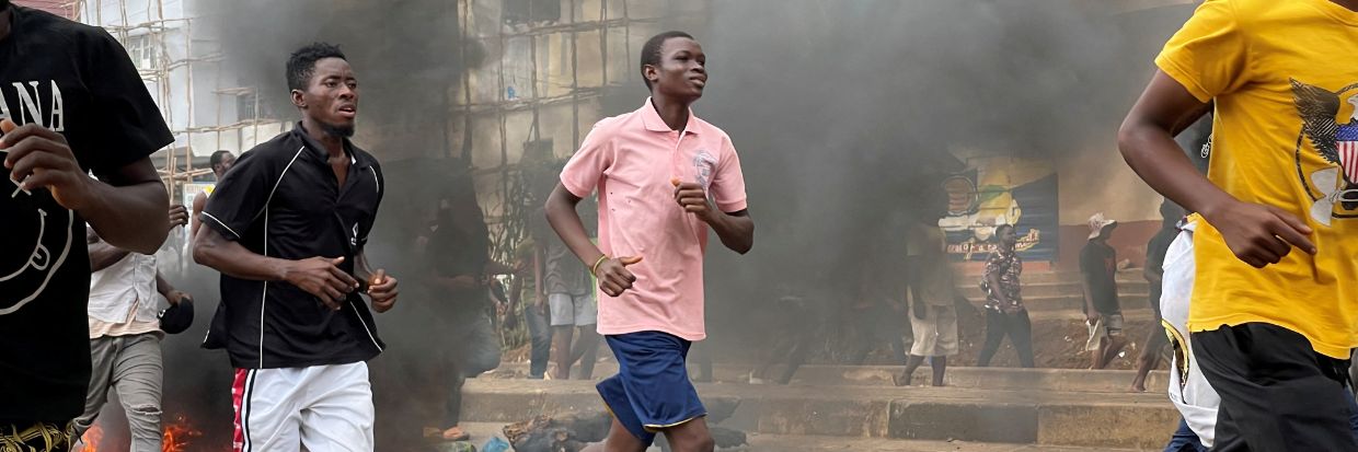 People run away during an anti-government protest, in Freetown, Sierra Leone, August 10, 2022, Reuters