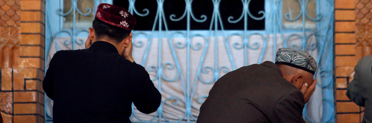 Uyghur men praying © EPA