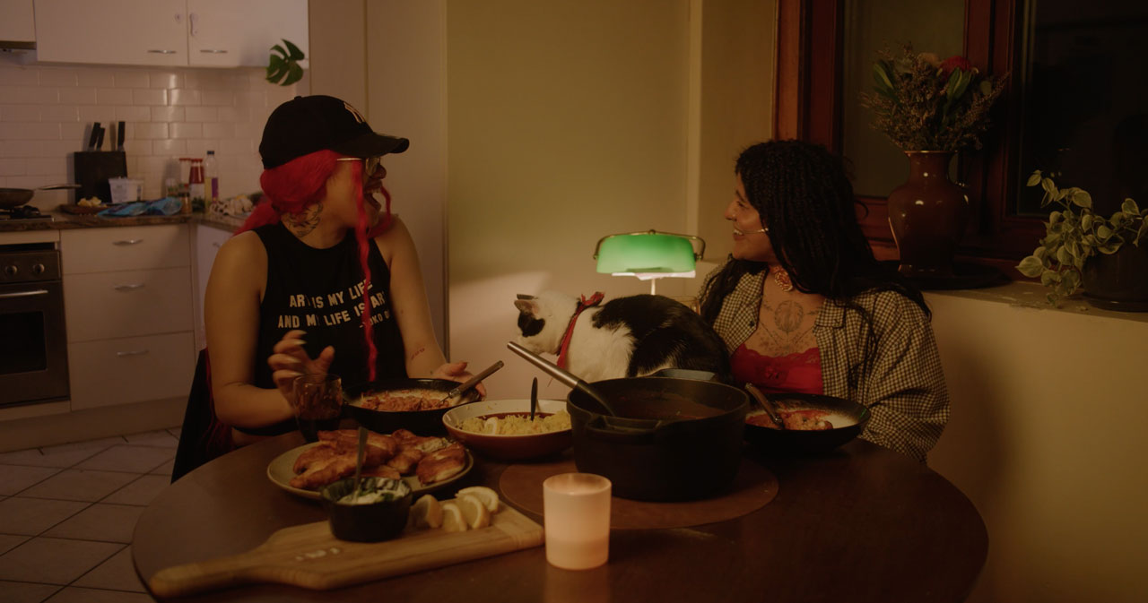 Two girls enjoying a cooked meatball curry together