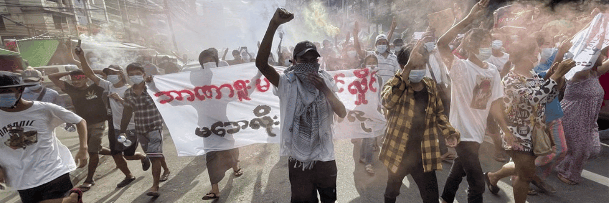 Demonstrators holding posters and flares as they march during an anti-military coup protest at downtown area in Yangon, Myanmar, 03 July 2021. © EPA-EFE