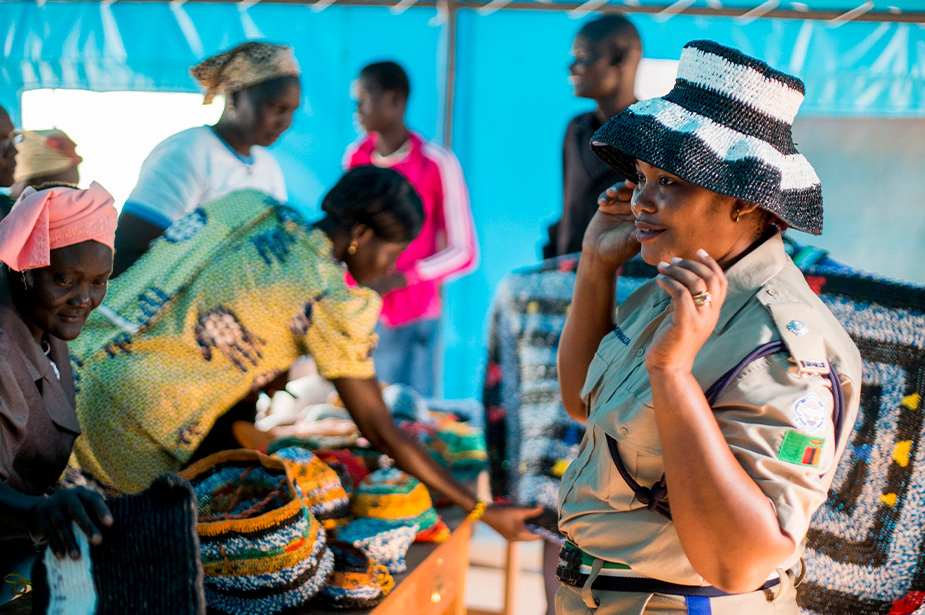 A peace keeper in South Sudan tries on a hat from a market seller. The market was part of a crisis prevent and recovery project sponsored by the United Nations. © UN Photo/JC McIlwaine