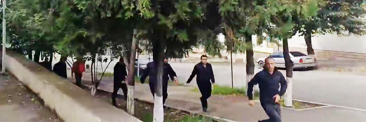 People run as gunfire and explosions are heard in Stepanakert, called Khankendi by Azerbaijan, in the Nagorno-Karabakh region, September 19, 2023, in this screengrab obtained from a handout video. © Artsakh Public TV/Handout via REUTERS