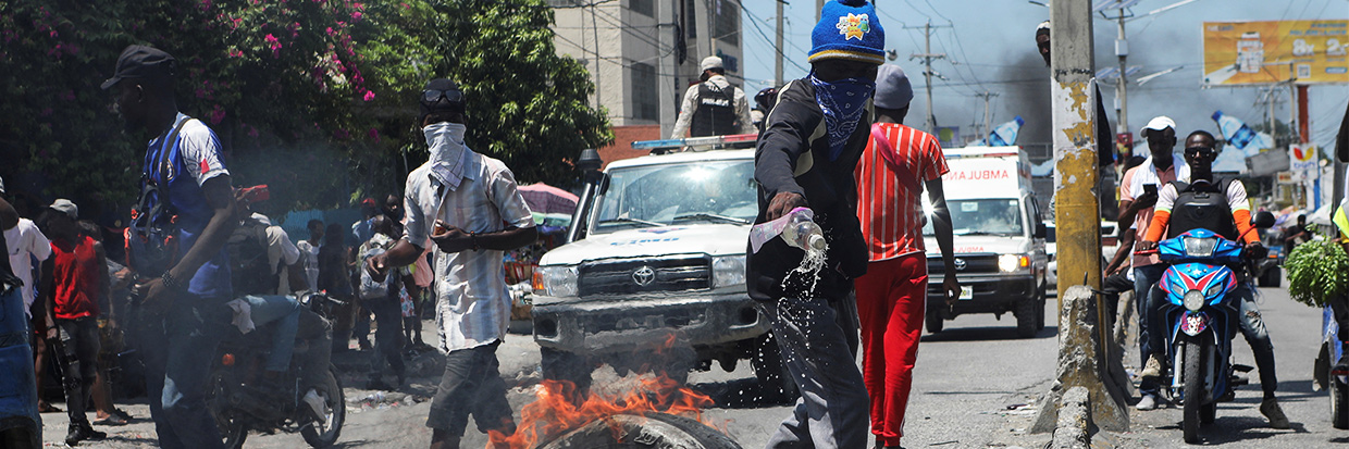 Un manifestant verse du carburant liquide sur des pneus pour les brûler à une barricade lors d'une manifestation contre l'insécurité et pour demander la démission du Premier ministre haïtien Ariel Henry, à Port-au-Prince, Haïti le 17 septembre 2023 REUTERS/Ralph Tedy Erol