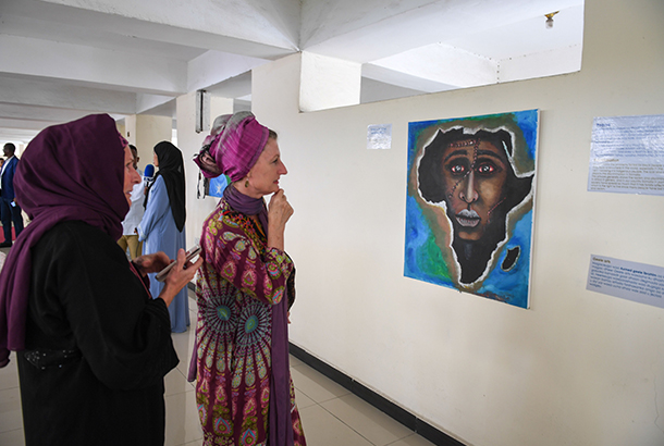 Two women looking at a work of art