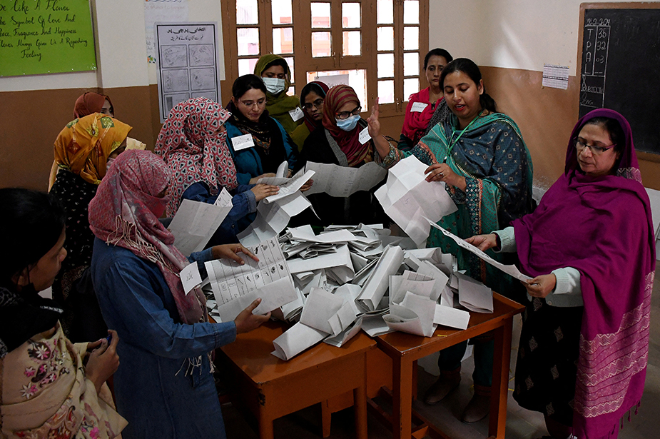 Polling staff count ballots during a general election in Hyderabad, Pakistan. © REUTERS/Yasir Rajput