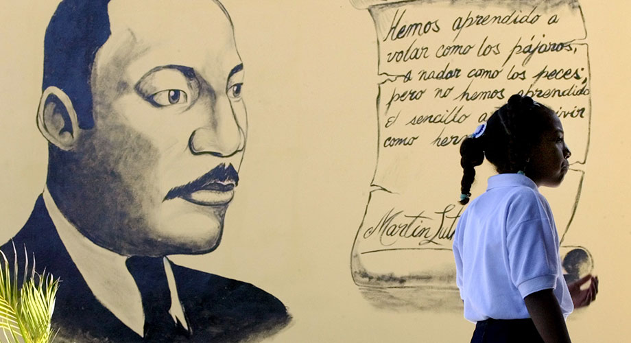 A Venezuelan schoolgirl stands in front of a mural with an image of U.S. civil rights activist, Martin Luther King, January 9, 2004. ©REUTERS/Jorge Silva JS/GAC.