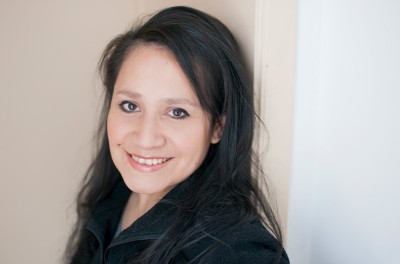 Izabel Lopez Raymundo smiling broadly in her home in Belgium. © Izabel Lopez Raymundo