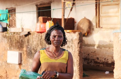 Arminda Sa poses for a photo outside her home in Bissau, Guinea-Bissau, February 6, 2019. © Thomson Reuters Foundation/Nellie Peyton