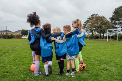 Kids playing football. © Getty  