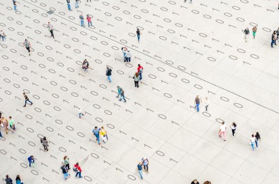 Crowd walking over binary code © Getty Images/Orbon Alija