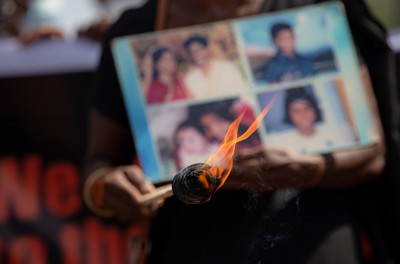 Relatives of the disappeared hold pictures of loved ones during a demonstration.© Kumanan Kanapathippillai