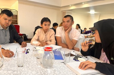 Four young people sitting around a table in a conference