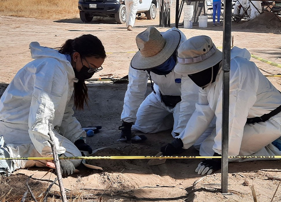 During a visit to Mexico in November 2021, the Committee on Enforced Disappearances accompanied an exhumation with forensic specialists and victims grabbing soil where they located dead bodies. © OHCHR