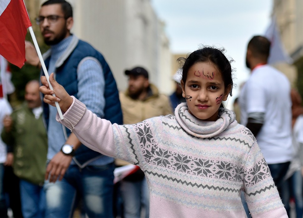 A girl carries a Lebanese flag during a protest organized for the campaign, My Nationality, My Dignity in 2019 © EPA-EFE/WAEL HAMZEH 