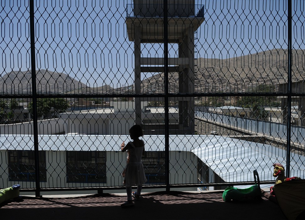 A girl stands in a playroom in the Kabul Female Prison and Detention Centre, Kabul, Afghanistan, June 2010.© UNICEF/UNI94658/Brooks