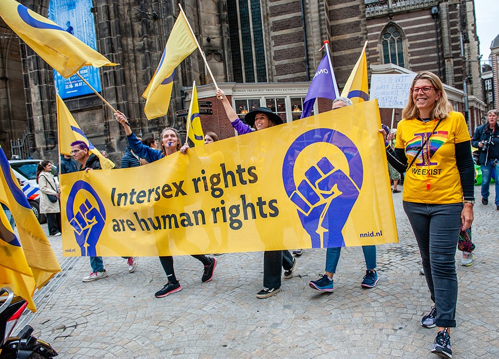 Des personnes défilent avec une bannière en faveur des droits des personnes intersexes lors d’une marche à Amsterdam. © SOPA Images/Ana Fernandez