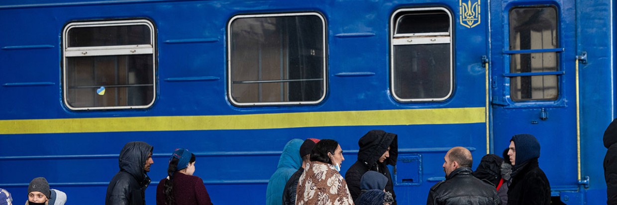 A family waiting at a train station. 