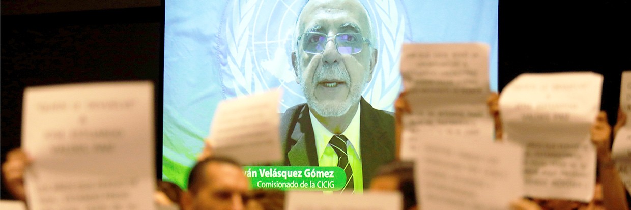 Ivan Velasquez, Commissioner of the International Commission against Impunity in Guatemala (CICIG) is seen speaking on a screen as people protest against the CICIG's latest report in Guatemala City, Guatemala August 20, 2019. REUTERS/Luis Echeverria