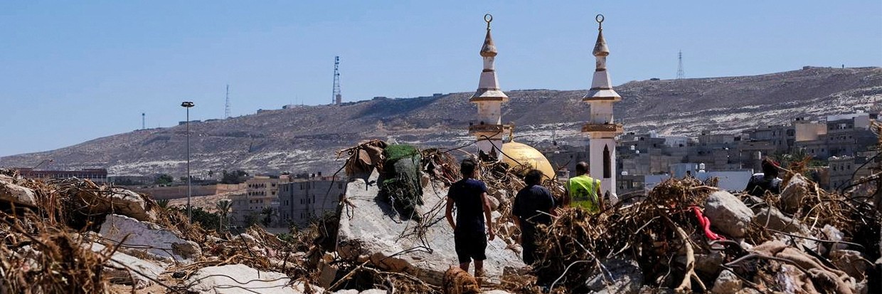 People walk amidst the debris, following a powerful storm and heavy rainfall hitting the country, in Derna, Libya September 13, 2023. Ⓒ REUTERS/Esam Omran Al-Fetori