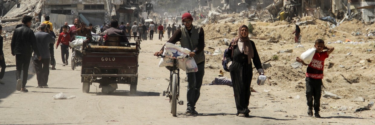 Palestinians carry aid as others struggle to receive their portion amid a widespread hunger, as the conflict between Israel and the Palestinian Islamist group Hamas continues, in Gaza City April 3, 2024. © REUTERS/Mahmoud Issa