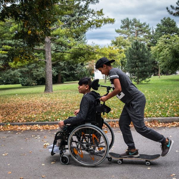 Two boys, one in a wheelchair and the other on a skateboard. Vienna, Austria, 2016. © UNICEF/UN039713/Gilbertson VII Photo