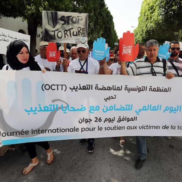 Tunisian protesters hold up signs marking the International Day in Support of Victims of Torture in Tunis, Tunisia, 26 June 2020. Banner reads: The Tunisian Organization Against Torture (OCTT) celebrates the International Day of Solidarity with Victims of Torture, corresponding to June 26. © EPA-EFE/Mohamed Messara