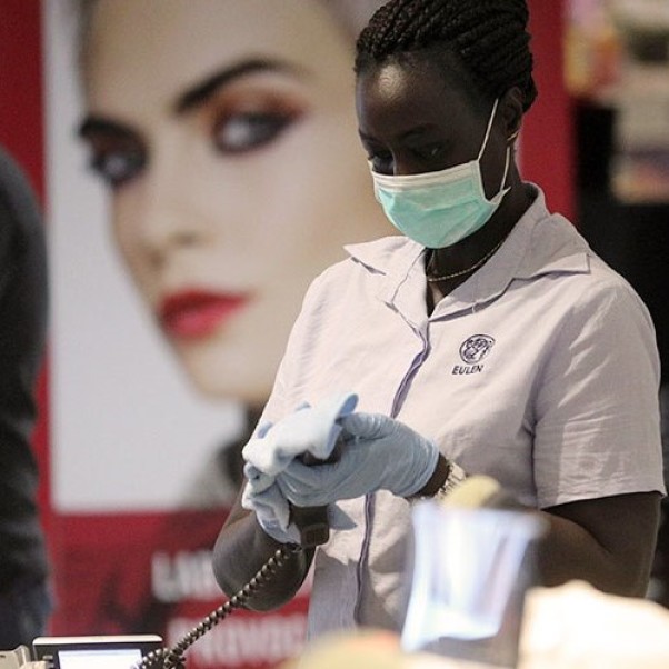 A woman sanitizing her equipment.