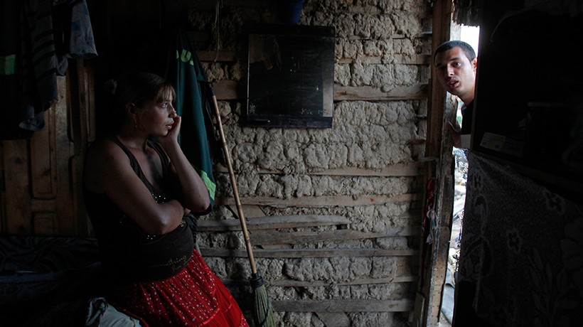 Interior of an adobe house, a man and a woman