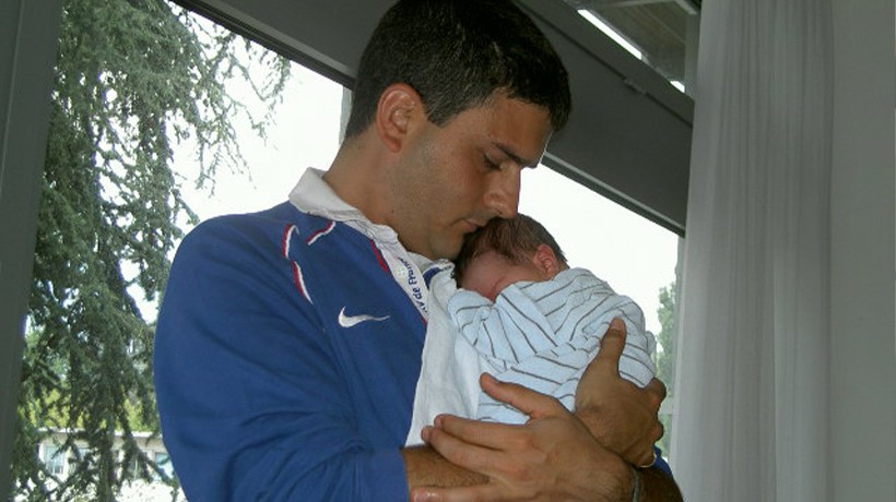 Jean-Sélim Kanaan cradling his newborn son, Mattia-Sélim