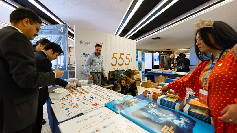 Participants read copies of the UDHR at a high-level event in Geneva to commemorate the 75th anniversary of its adoption. ©OHCHR/ Pierre Albouy