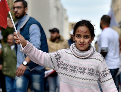 A girl carries a Lebanese flag during a protest organized for the campaign, My Nationality, My Dignity in 2019 © EPA-EFE/WAEL HAMZEH 