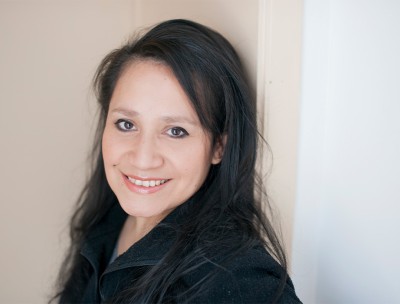 Izabel Lopez Raymundo smiling broadly in her home in Belgium. © Izabel Lopez Raymundo