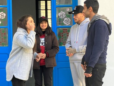 Three youngsters communicate through sign language. © Credit – OHCHR Tunisia