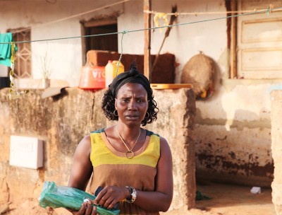 Arminda Sa poses for a photo outside her home in Bissau, Guinea-Bissau, February 6, 2019. © Thomson Reuters Foundation/Nellie Peyton