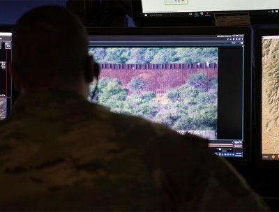 A border patrol agent monitors a live feed at a US border patrol station, 2022.  © Thomson Reuters Foundation/Rebecca Noble