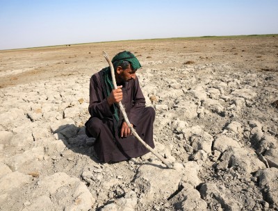 A Marsh Arab man looks at a dry ground that was covered with water near Chibayish in southern Iraq © REUTERS