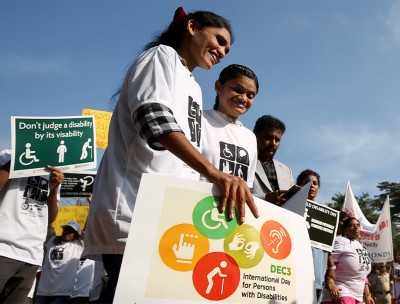 People with disabilities hold placards during the International Day of Persons with Disabilities in Bangalore, India. © EPA 