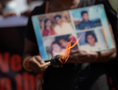 Relatives of the disappeared hold pictures of loved ones during a demonstration.© Kumanan Kanapathippillai