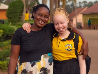 Elizabeth Ayebere, 14, and her mother Scovia Nsimenta, embrace after her enrolment into a new school. ©OHCHR Photo