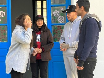 Three youngsters communicate through sign language. © Credit – OHCHR Tunisia