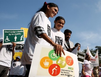 People with disabilities hold placards during the International Day of Persons with Disabilities in Bangalore, India. © EPA 