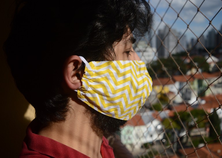 An adolescent boy wearing a protective mask