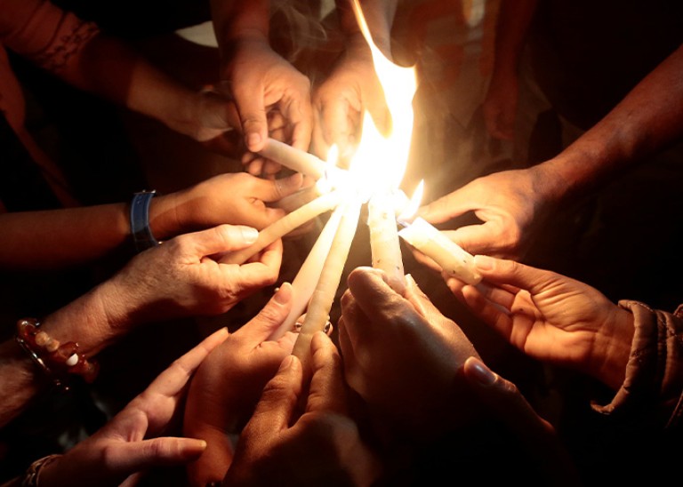 Activists light candles during a vigil for the murder of Costa Rican indigenous rights activist Sergio Rojas in 2019 © Reuters