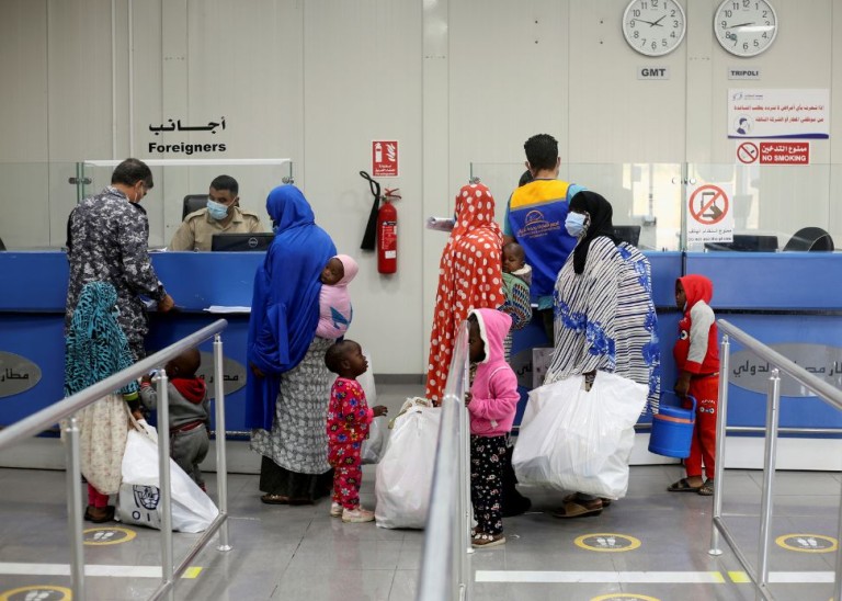 Migrants check in to be deported back to their country at Misrata Airport in Misrata, Libya, November 3, 2021, Reuters