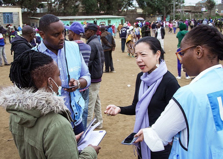 On election day, members of the OHCHR Surge Team engage with human rights defender, Maryanne Kasina, at a polling station in Nairobi. © OHCHR Photo/Stephen Kibunja  