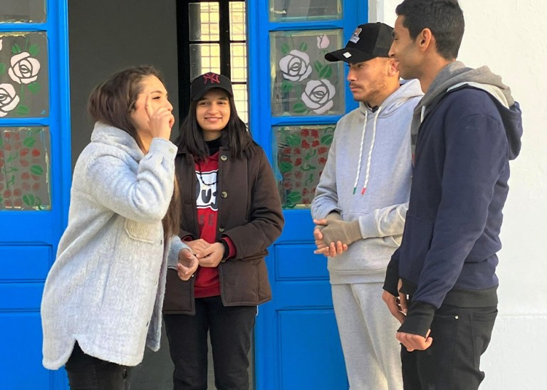 Three youngsters communicate through sign language. © Credit – OHCHR Tunisia